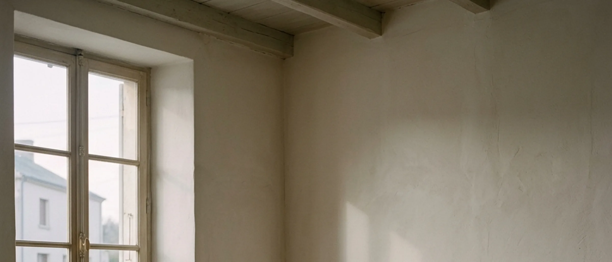 A quiet, morning-lit room with soft shadows on the floor.